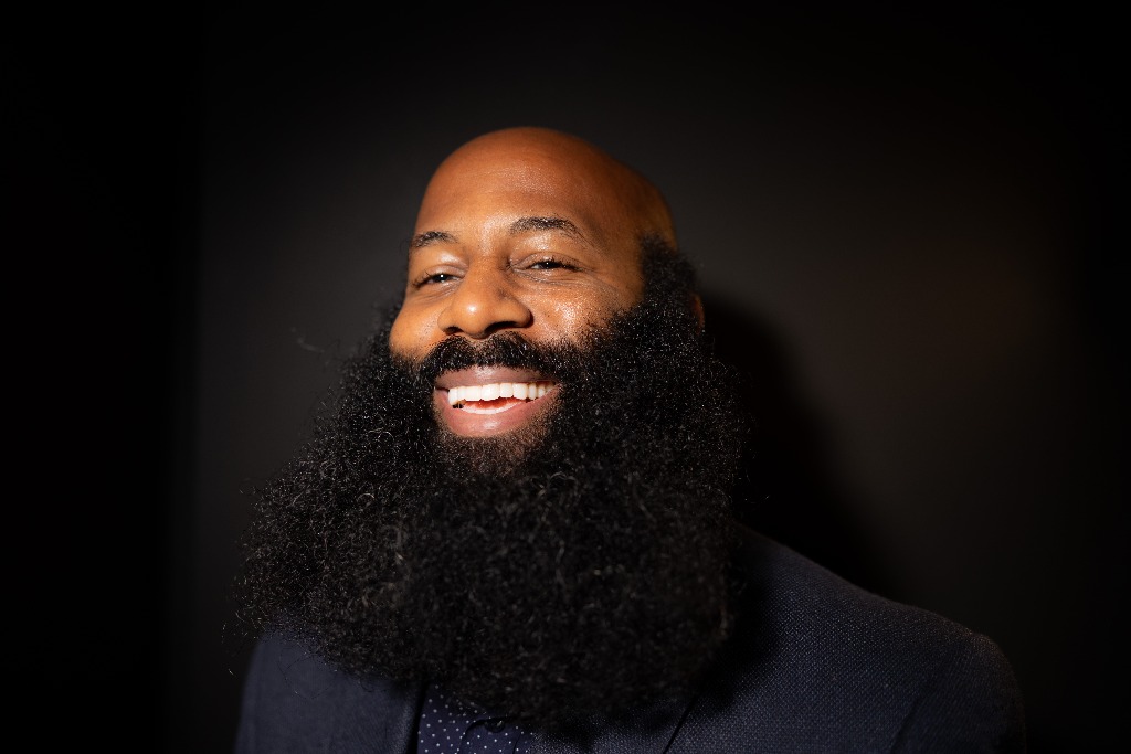Anson laughing in the studio, full beard looking healthy and natural.